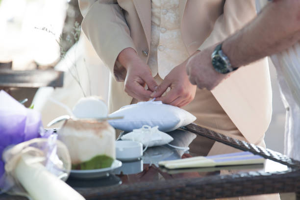 istock groomsman placing two wedding rings on a pillow 974466434