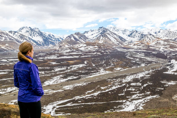 istock Woman looking at mountain range 974476374