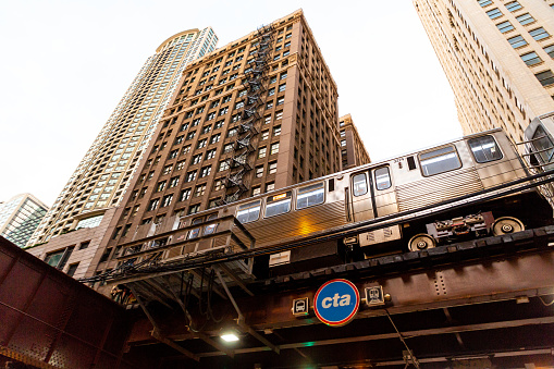 CHICAGO, ILLINOIS - MAY 31, 2018: A CTA L train rolls through elevated tracks in the loop on a spring day.