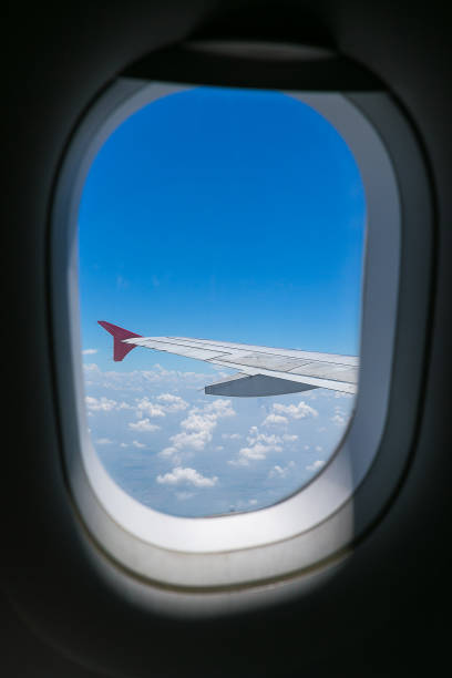 istock Clouds and sky as seen through window of an aircraft. 974533882
