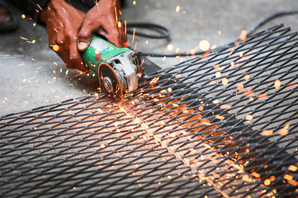 istock Electric wheel grinding on steel structure on sieve. 974535056