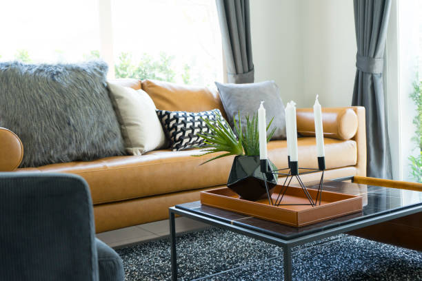 Brown leather couch and decorative southwestern pillows in a modern bohemian desert home