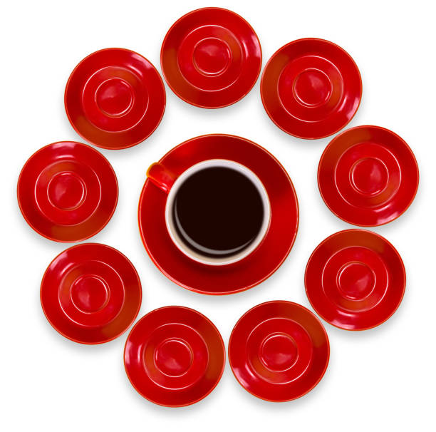 Creative layout of red coffee cups and a saucer on a white background. View from above