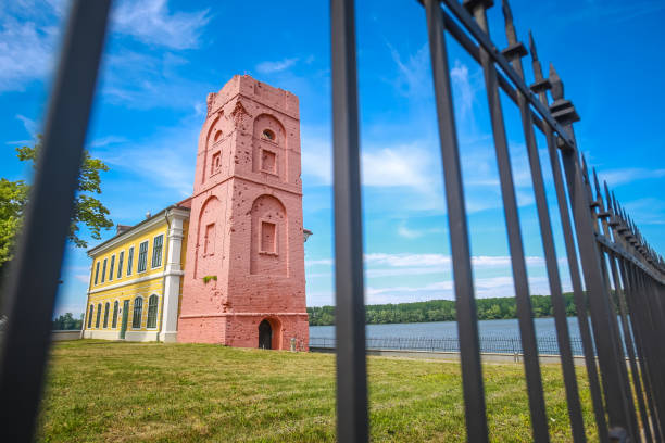 Renovated tower of the City museum Vukovar, Croatia - May 14, 2018 : Renovated tower that is part of the City museum on the coast of river Danube viewed thru the fence in Vukovar, Croatia. eltz castle croatia stock pictures, royalty-free photos & images