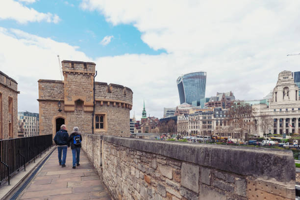 old buildings and towers in the inner ward area of royal palace and fortress of the tower of london, a historic castle and popular tourist attraction located on the north bank of the river thames in central london, england - built structure church flint stone imagens e fotografias de stock