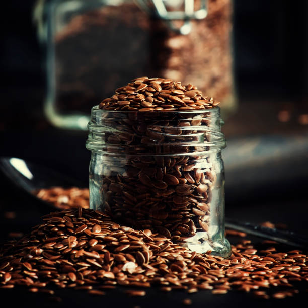 istock Flax or linen seeds in jar 974603968