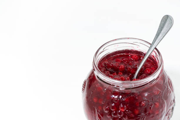 istock jar with sweet cowberry jam on white background 974611744