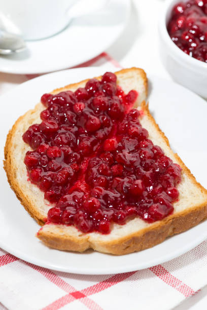 toast with cranberry jam for sweet breakfast, vertical top view
