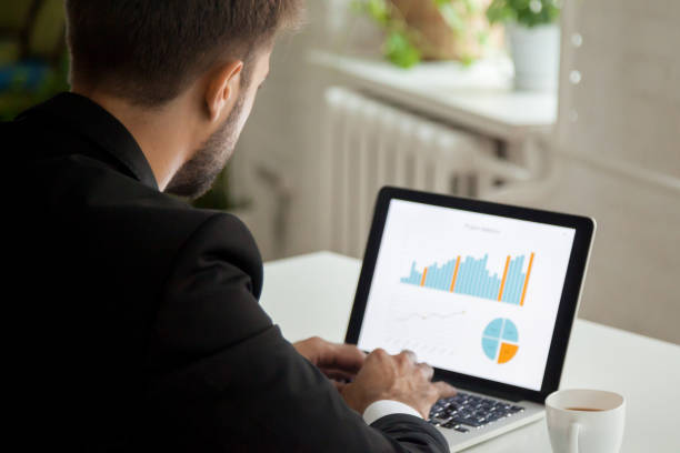 istock Thoughtful businessman working at laptop analyzing financial data 974617726