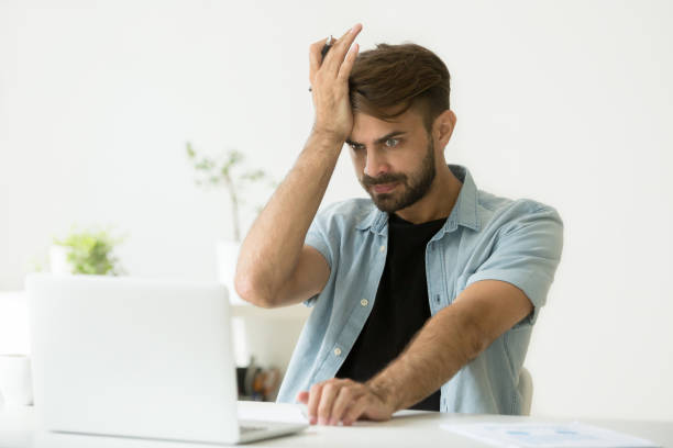 istock Confused man stressed about performing mistake in report 974617756