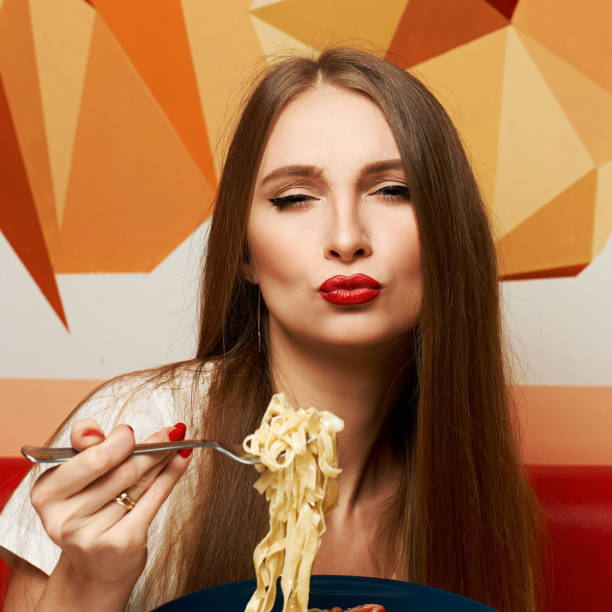 istock Attractive woman eating seafood pasta 974620990