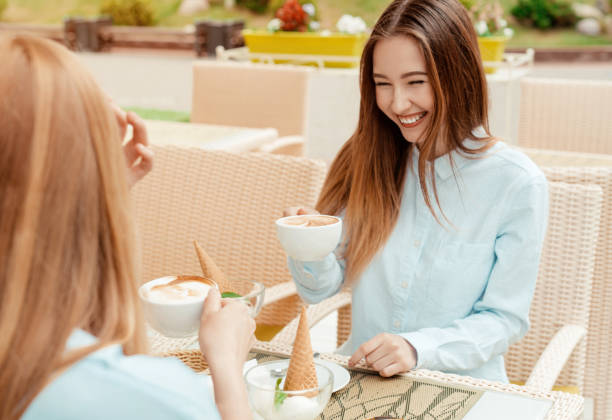 istock happy girlfriends together in a cafe drink coffee and talking 974624012