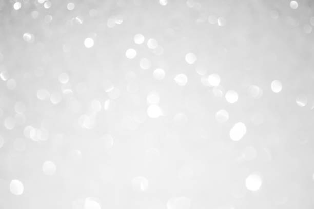 istock white blur abstract background. bokeh christmas blurred beautiful shiny Christmas lights 974624094