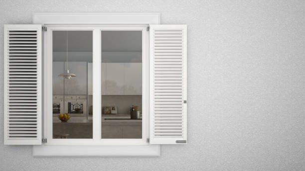 istock Exterior plaster wall with white window with shutters, showing interior modern kitchen with island, blank background with copy space, architecture design concept 974624198