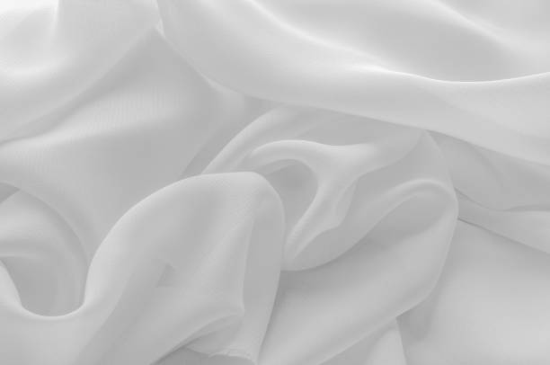 istock Texture, background, pattern. Silk fabric of white color, abstract folds. 974627566