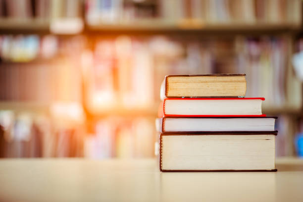 istock Book stack is placed on the library desk. education background, back to school concept. 974627906