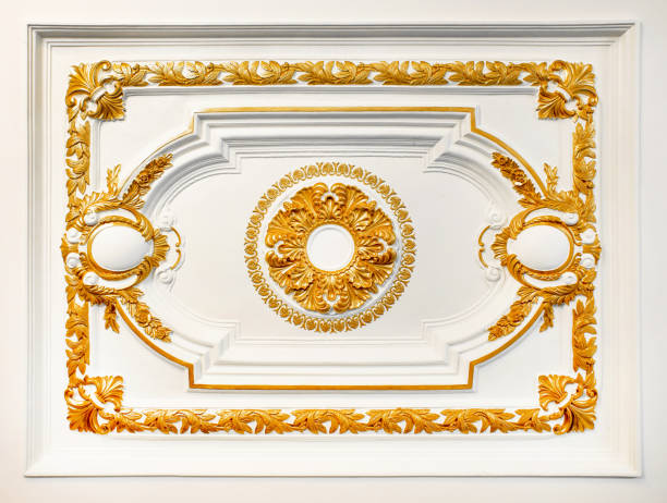 istock Pattern of gold flower carved on concrete white wall texture background 974630452