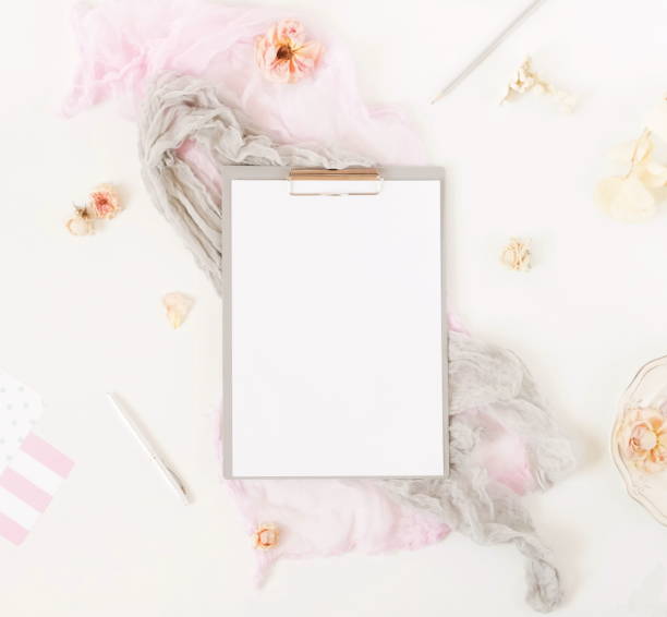 istock Creative festive composition with  frame mock up, pink blanket, flowers, eucalyptus branches, roses on white background. Flat lay, top view stylish template. 974631078