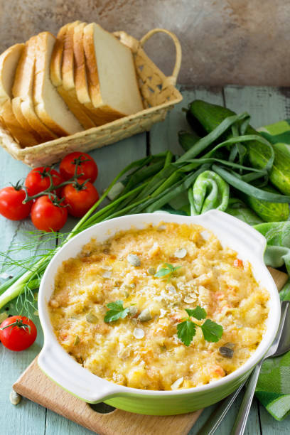 istock Casserole crumble with red fish, white bread and cheese on the kitchen wooden table. Proper nutrition. Copy space. 974634318