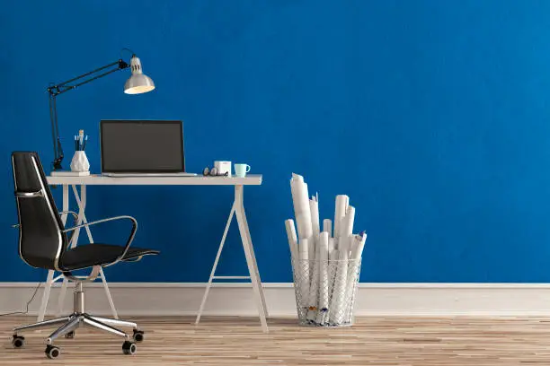 Workdesk with decoration on hardwood floor in front of empty grey wall with copy space. 3D rendered image.