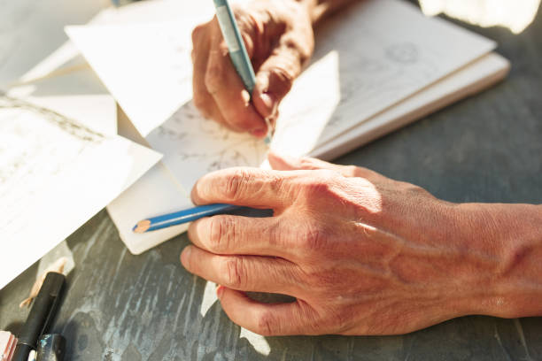 istock Close up man working of Architect sketching a construction project on his plane project at site construction work 974637560