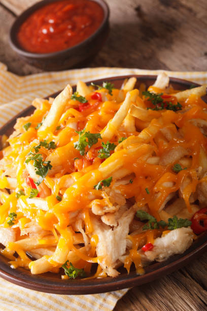 istock french fries with cheddar cheese and chicken meat macro. vertical 974637580