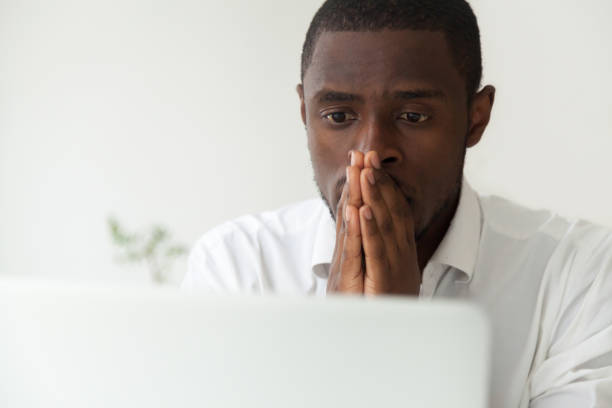 istock Thoughtful African American worker hoping for computer start ope 974640832