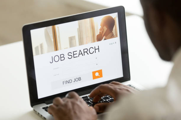 istock Black unemployed worker looking for open job positions online 974640838