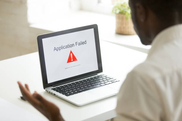 istock Frustrated black worker getting virus notification at laptop scr 974640886