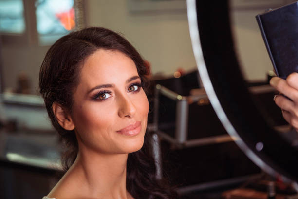 istock Professional makeup artist working on a beautiful model in the studio 974643272