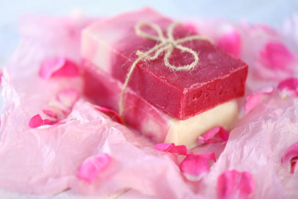 istock handmade rose soap . Soap with rose petals extract close-up.cosmetics with rose extract. 974643998