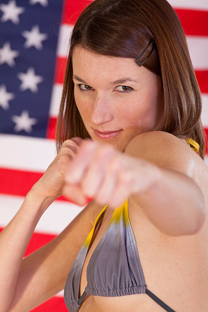 istock fighting woman over american flag 97465967