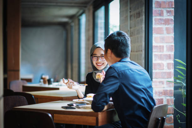 istock Multi ethnic couple eating pasta in restaurant 974663244