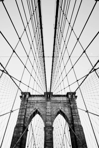 Brooklyn Bridge cables Brooklyn Bridge cables and suspension ties with one of the brick support towers and the climb prevention devices. brooklyn bridge photos stock pictures, royalty-free photos & images