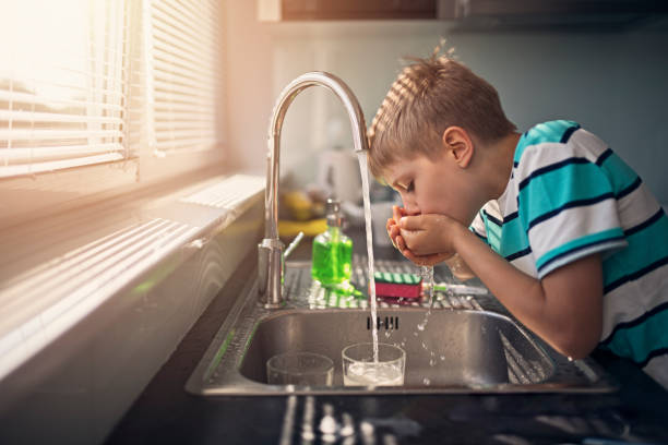 Little boy drinking tap water