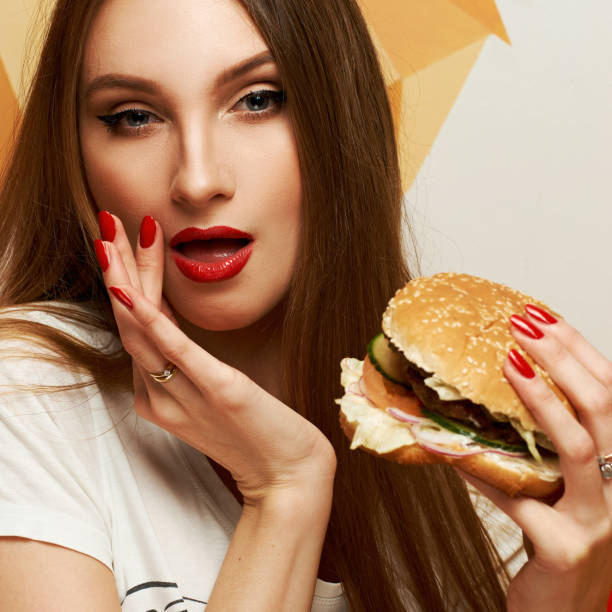 istock Playful girl posing with burger 974664354
