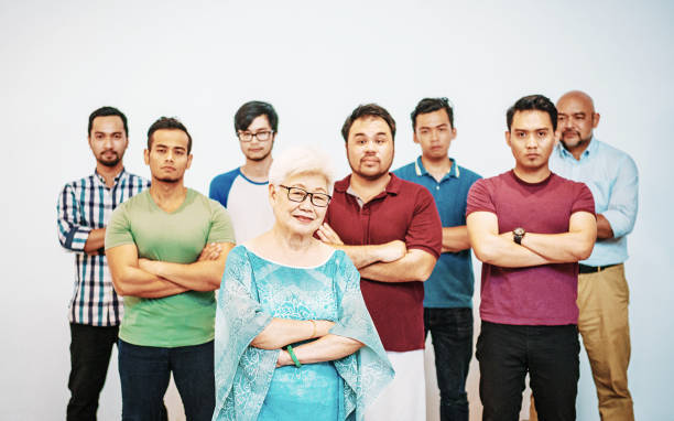 istock Senior woman supported by younger men 974666812