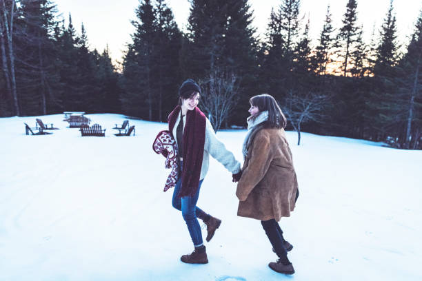 istock Lesbian couple at their front yard during winter 974667554