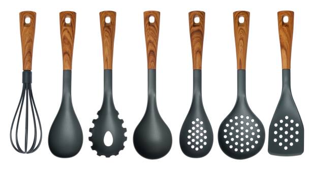 istock Plastic kitchen utensils isolated on white. Spoon, spatula, strainer, ladle, colander, whisk. 974667568