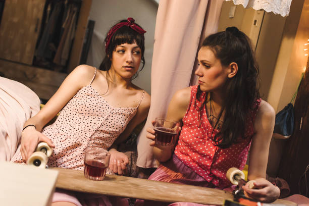 istock Two young women drinking alcohol together 974668116