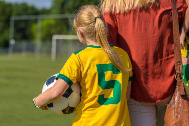 istock Soccer Mom preparing her blond daughter for football training 974671602