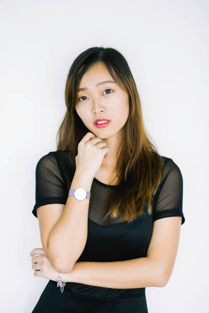 istock Young woman standing against a grey wall. 974675924