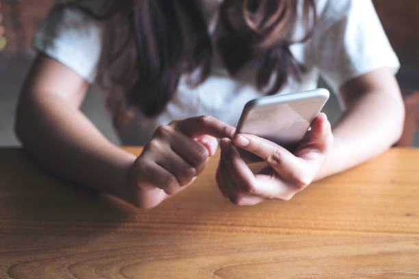 istock Closeup image of a woman holding , using and touching a smart phone 974676380