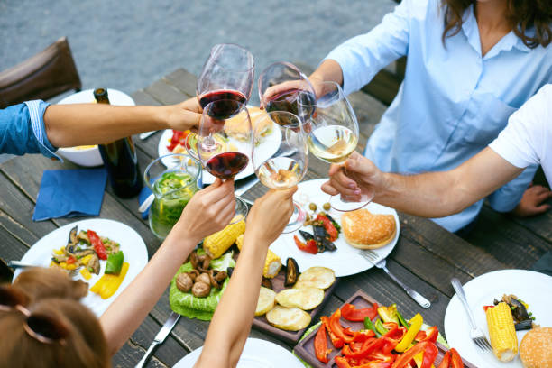 istock People Cheering With Drinks At Outdoor Dinner Party 974676730