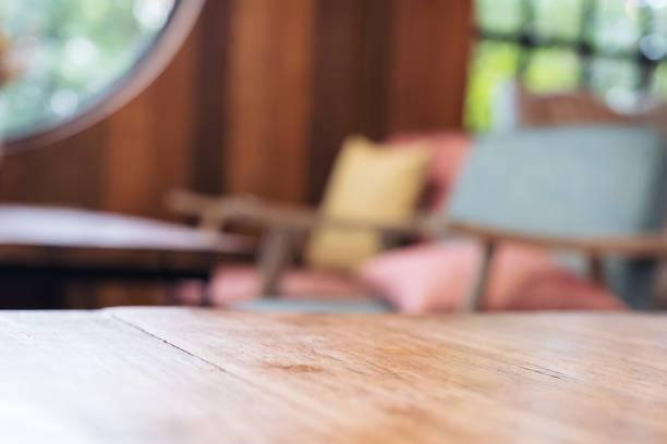 istock Wooden table and chair in cafe with blur bokeh background 974679710
