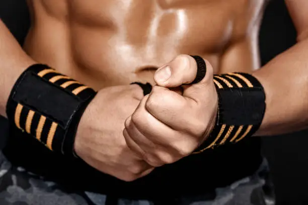 Photo of man wraps his wrist with sports wrap