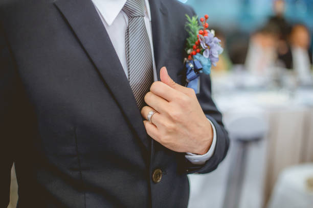 istock The married man holding collar of his suit jacket. 974683550