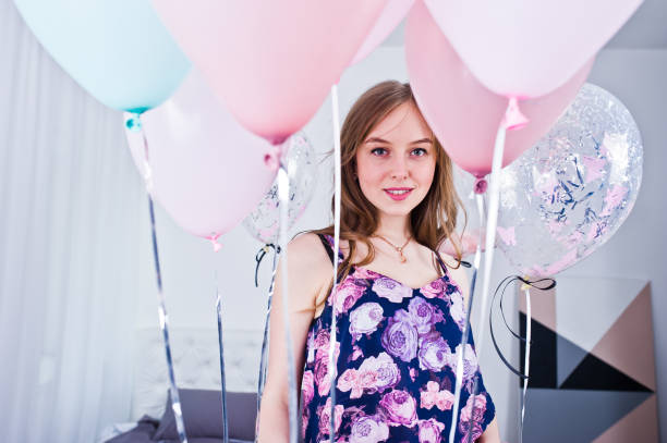 istock Happy girl with colored balloons 974685000