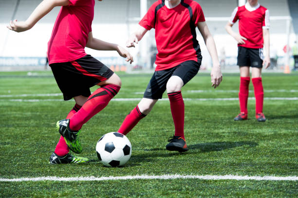 istock Unrecognizable Boys Playing Football in Field 974687946