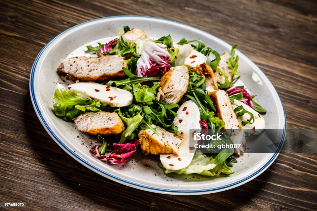 Caesar salad Caesar salad on wooden background Antipasto Stock Photo